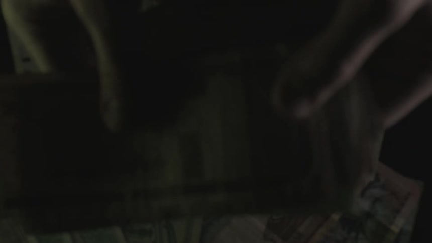 A person flips through paper money