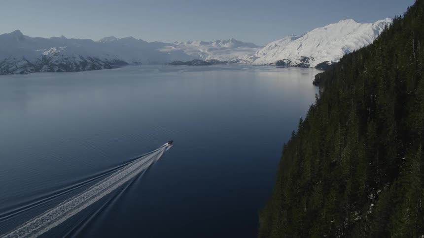 A boat sails in the water below