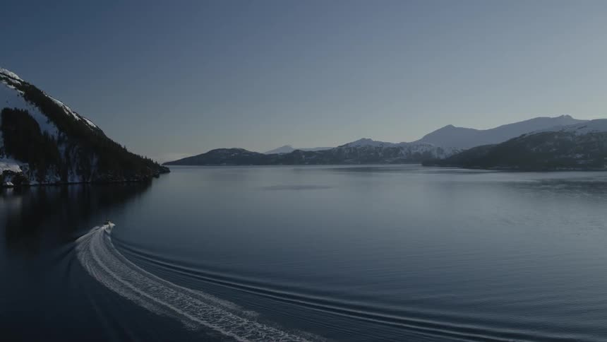 Boat making waves in a large lake