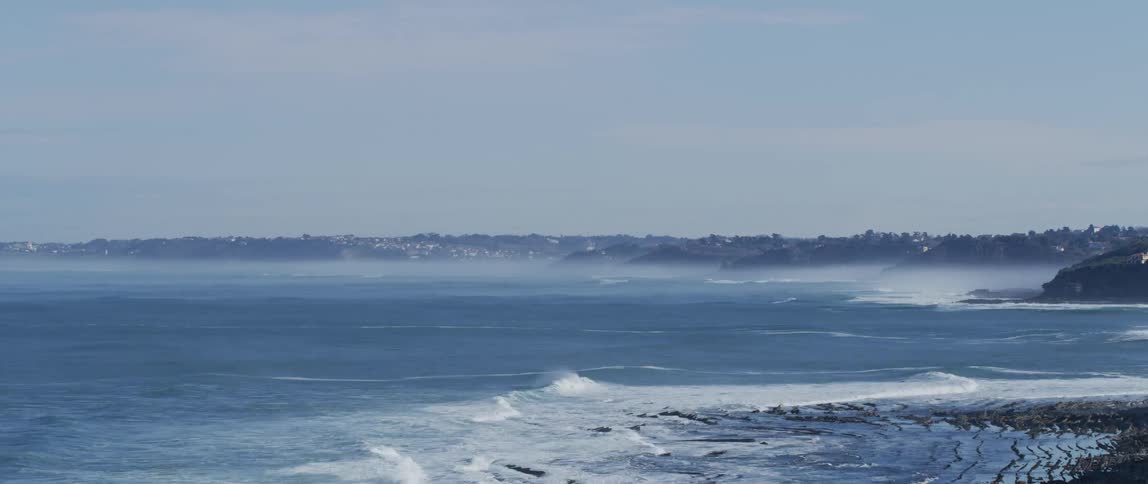Small waves wash onto the shore of a beach