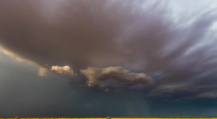 Wind during storm front blows dust through the air as it flows across the countryside
