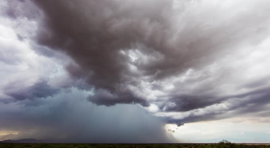A large storm dumping tons of rain and moving across desert lands