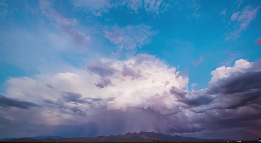 A thunderstorm in the distance with clear skies above and lightning