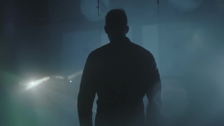 A man watches images projected on a screen