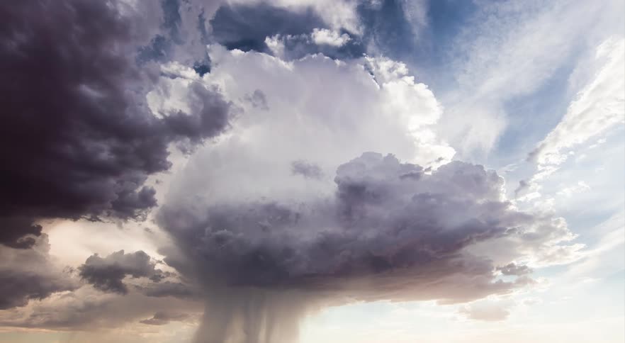 Wide isolated thunderstorm with a huge microburst dumping over the desert and dust