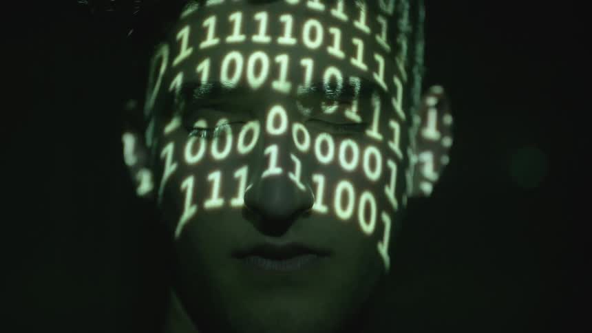 A man has lights on his face that show numbers