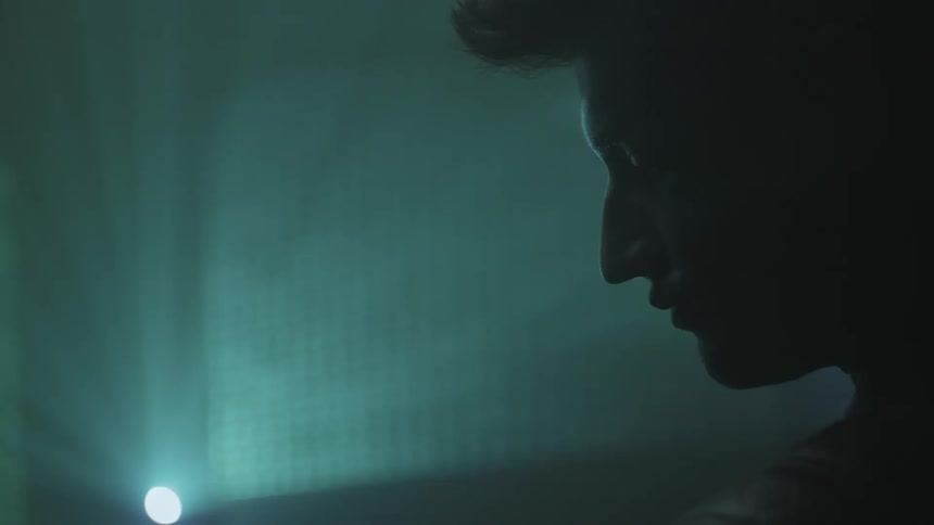 A man wakes up looking at numbers displayed on the wall