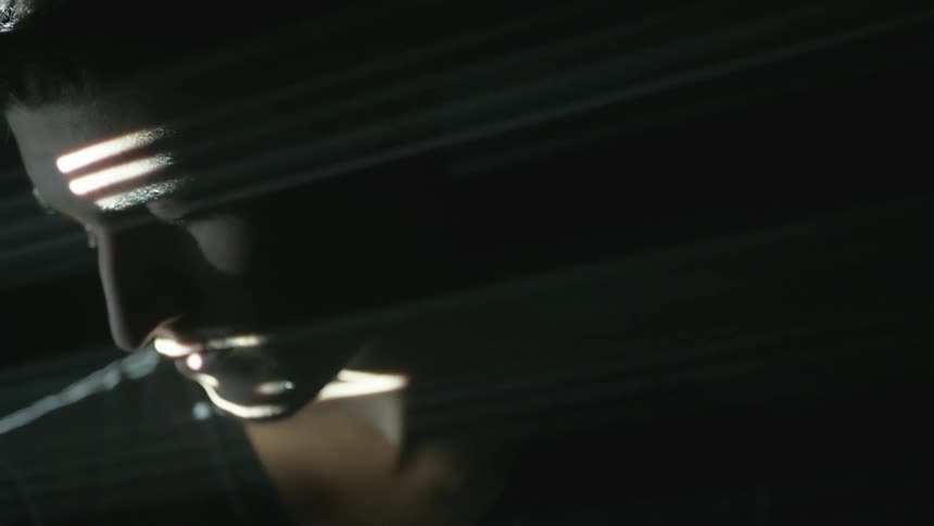 Light shines on a man's face