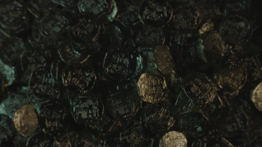 Gold coins drop onto a pile of coins