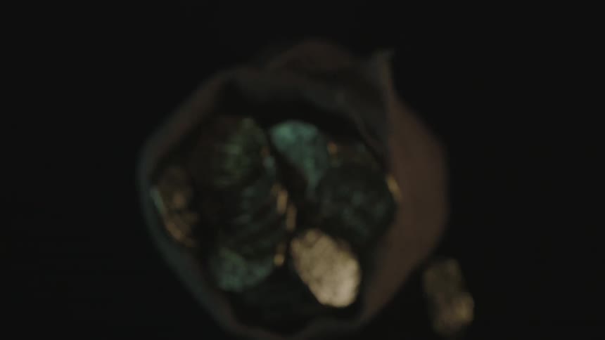 A bag of gold coins falls on the ground