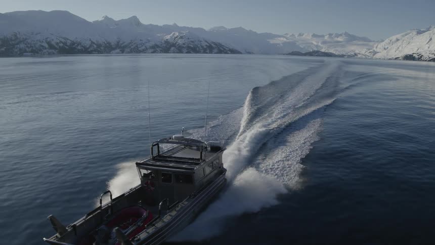 A boat cuts through the water leaving a wake
