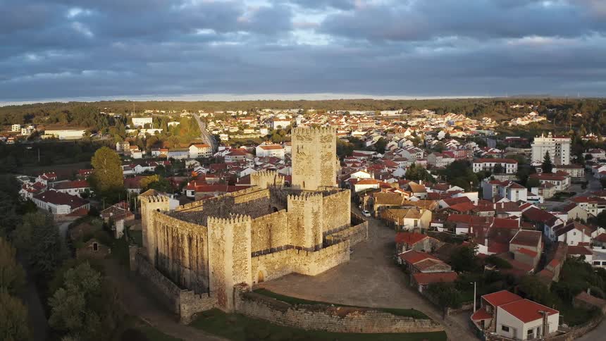 Fortification sits on edge of town of red roofed buildings
