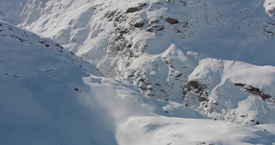 Aerial view of snowy mountain slopes and valley