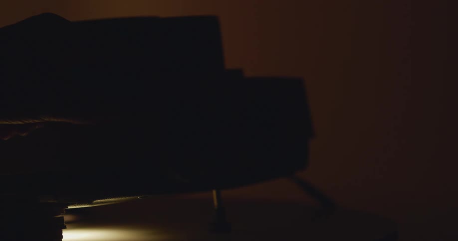 Person operates projector in dimly lit room