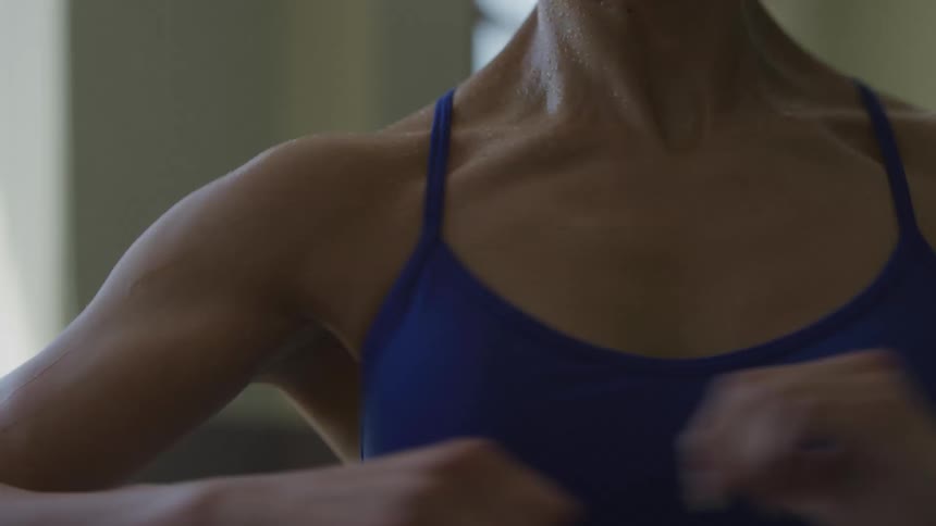 A woman spins around in a dance studio