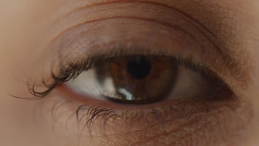 A person slowly opens their eye