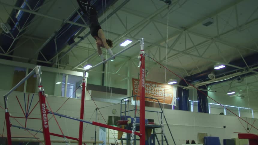 A woman is doing gymnastics in the gym