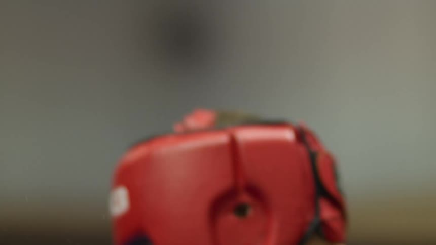 A man being punched in the face while boxing with an opponent