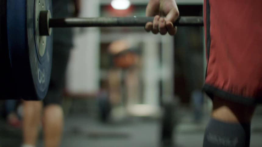 A man is lifting weights in the gym