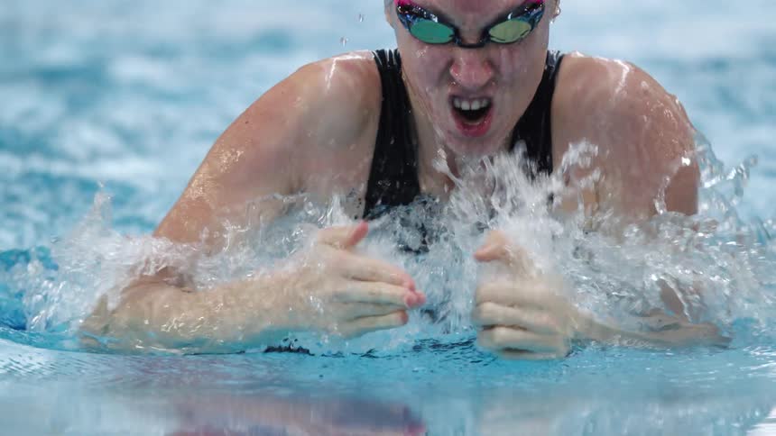 A woman is swimming in the pool