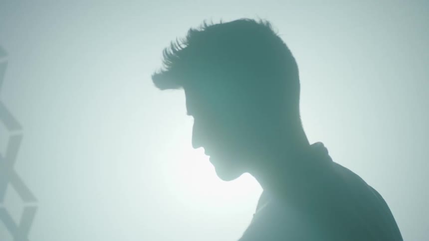 Projected images flash with a man putting a shadow over it