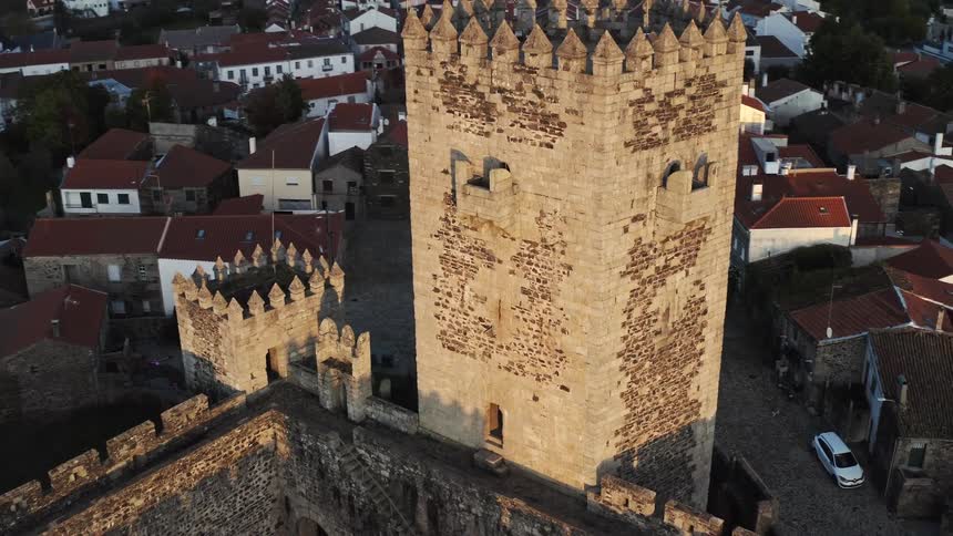 Aerial view of the towers and walls of an old castle in portugal at evening