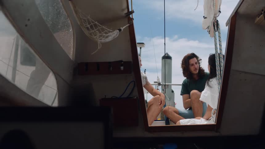 People talk and sit on the boat