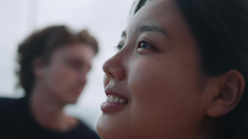 A girl is smiling near a friend