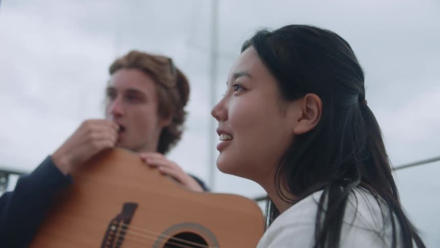 Man and woman nod as they listen to another while sitting on sailboat