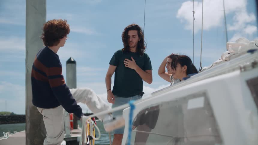 A group of friends are getting onto a boat together