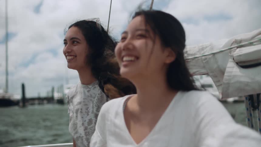 Two women laugh together on the boat