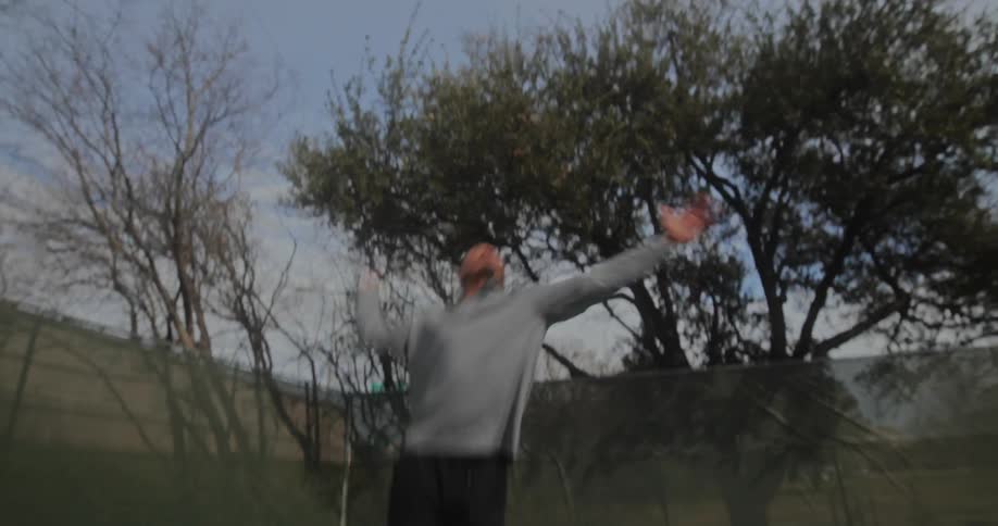 Man serving tennis ball in a tennis court