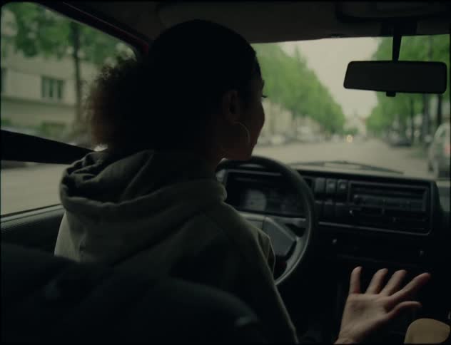 A couple argue while driving down a city street