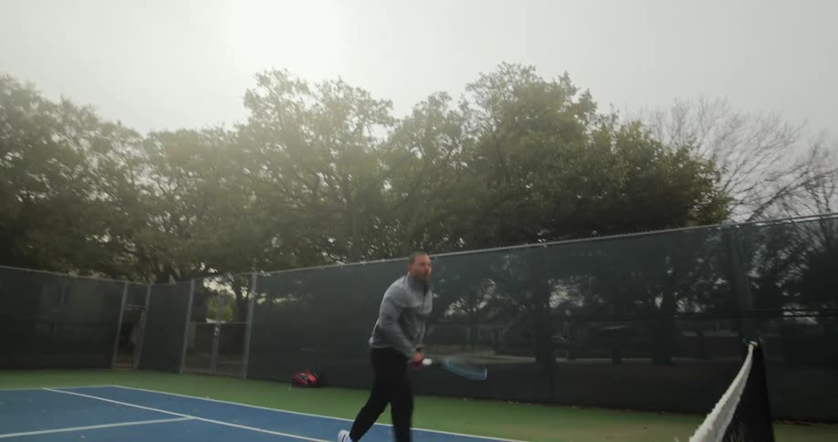 A man hits the ball with a tennis racquet