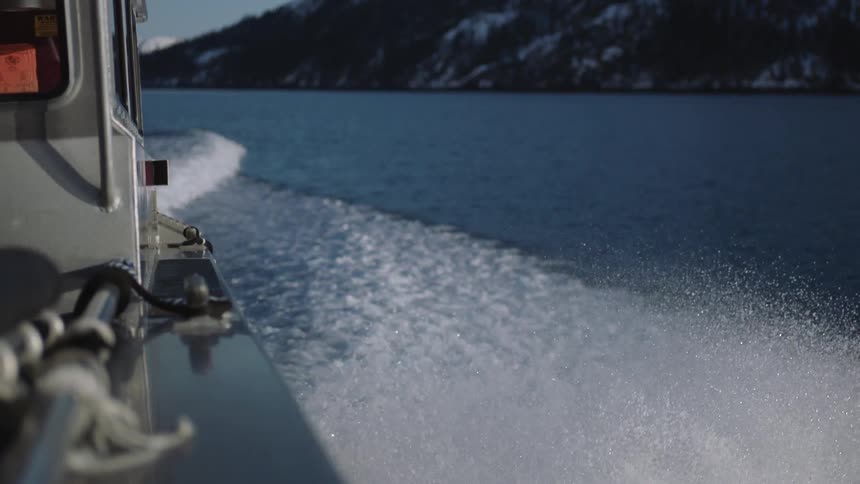 A boat is splashing water as it sails