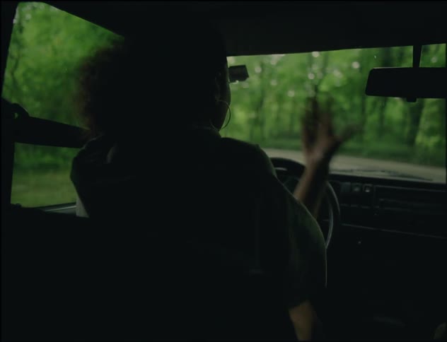 A woman driving through a desolate wilderness angrily berating the man sitting beside her as they navigate a remote road