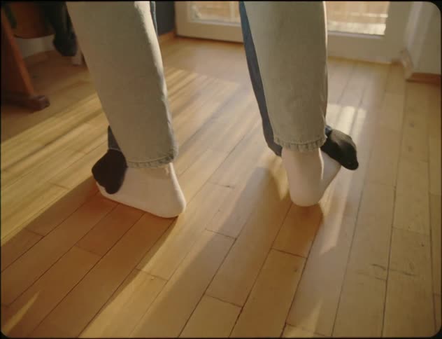 Two dancers performing a synchronized routine with their legs entwined in a dynamic display of agility and coordination