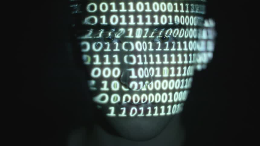 Lines of zeros and ones are projected over a man's face