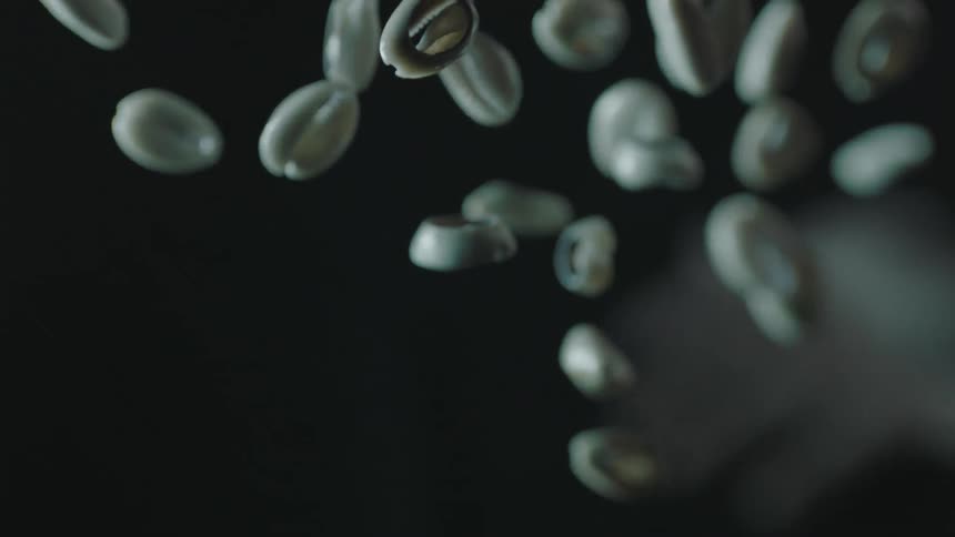 Handful of nuts being thrown into the air and then bouncing to the ground