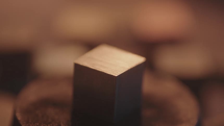 A metal cube in flickering light