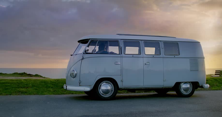 A van parked on the side of a street outside at sunset