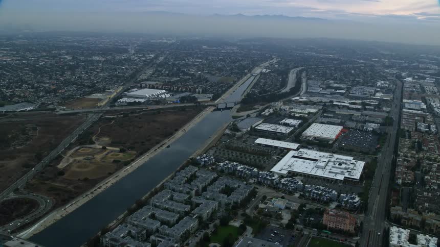 A breathtaking aerial shot of the Los Angeles river canal during sunrise over Marina Del Rey California