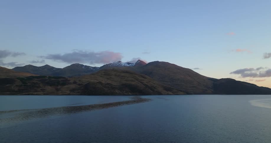 A landscape view of coastal mountains with snow