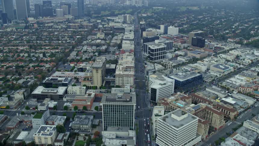 Aerial footage of morning rush hour traffic on Wilshire Boulevard as seen on a misty day in Beverly Hills California