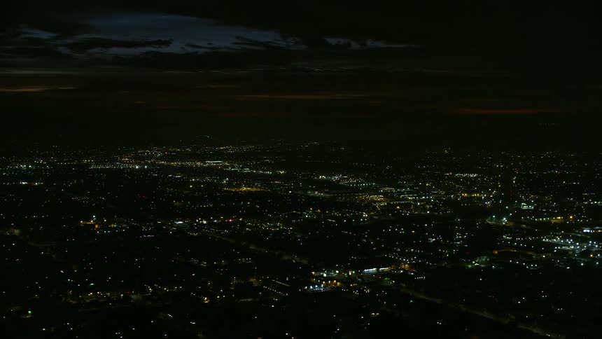 A stunning aerial footage of suburban neighborhoods at night in Burbank CA with mesmerizing city lights