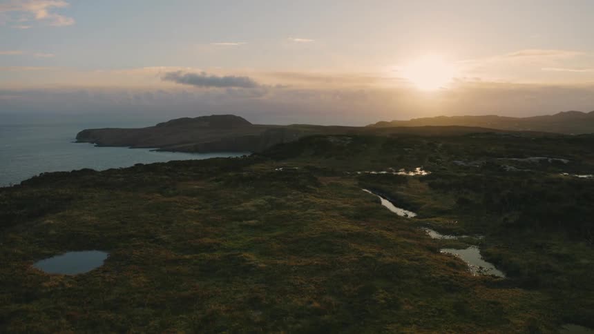 The sun setting over a coastal landscape