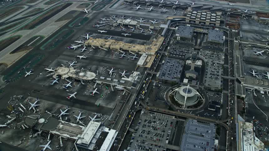 Aerial footage of parked airplanes at LAX during sunrise in Los Angeles California