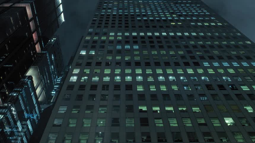 Timelapse footage of night falling over the tall skyscrapers on the city downtown