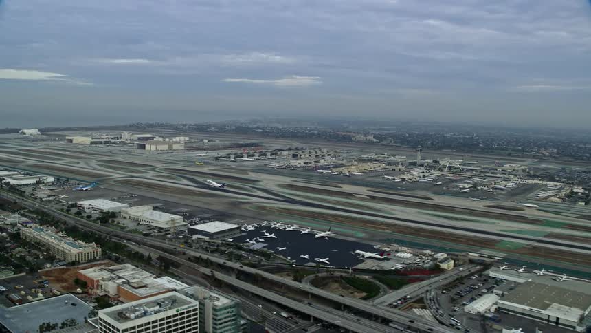 A FedEx airplane takes off from LAX airport in the morning as seen in this aerial footage over California