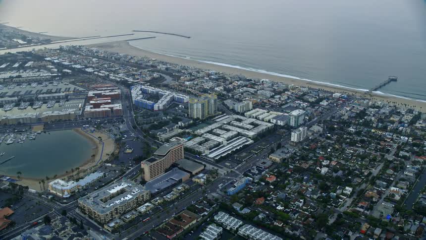 Flying over Venice towards Marina Del Rey condominium complexes at sunrise capturing the beautiful Southern California shoreline and West Coast condominiums
